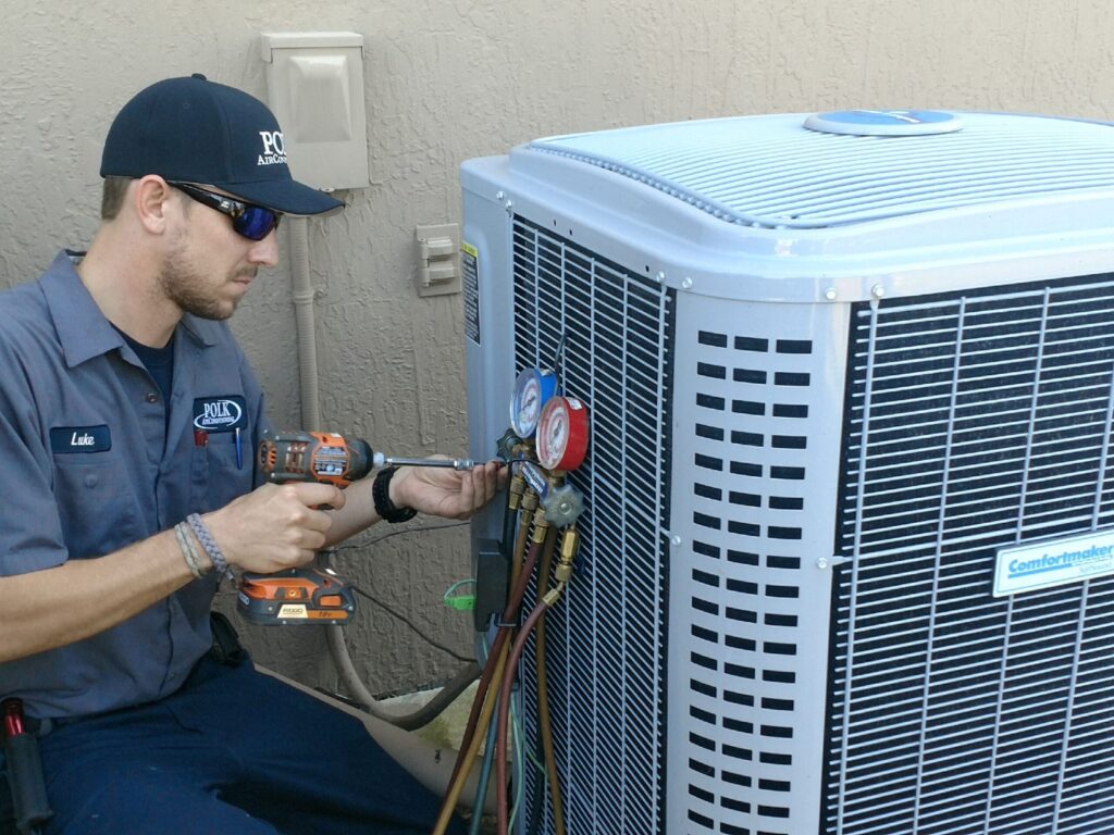 HVAC technician working on an AC unit.